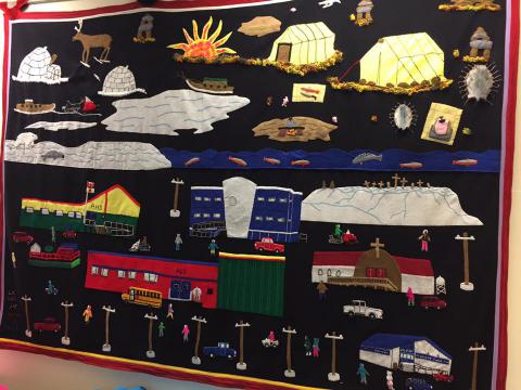 Igloolik community tapestry on display at the Ataguttaaluk High School in June 2017. The RCYO spent time meeting with a variety of child and youth service providers.